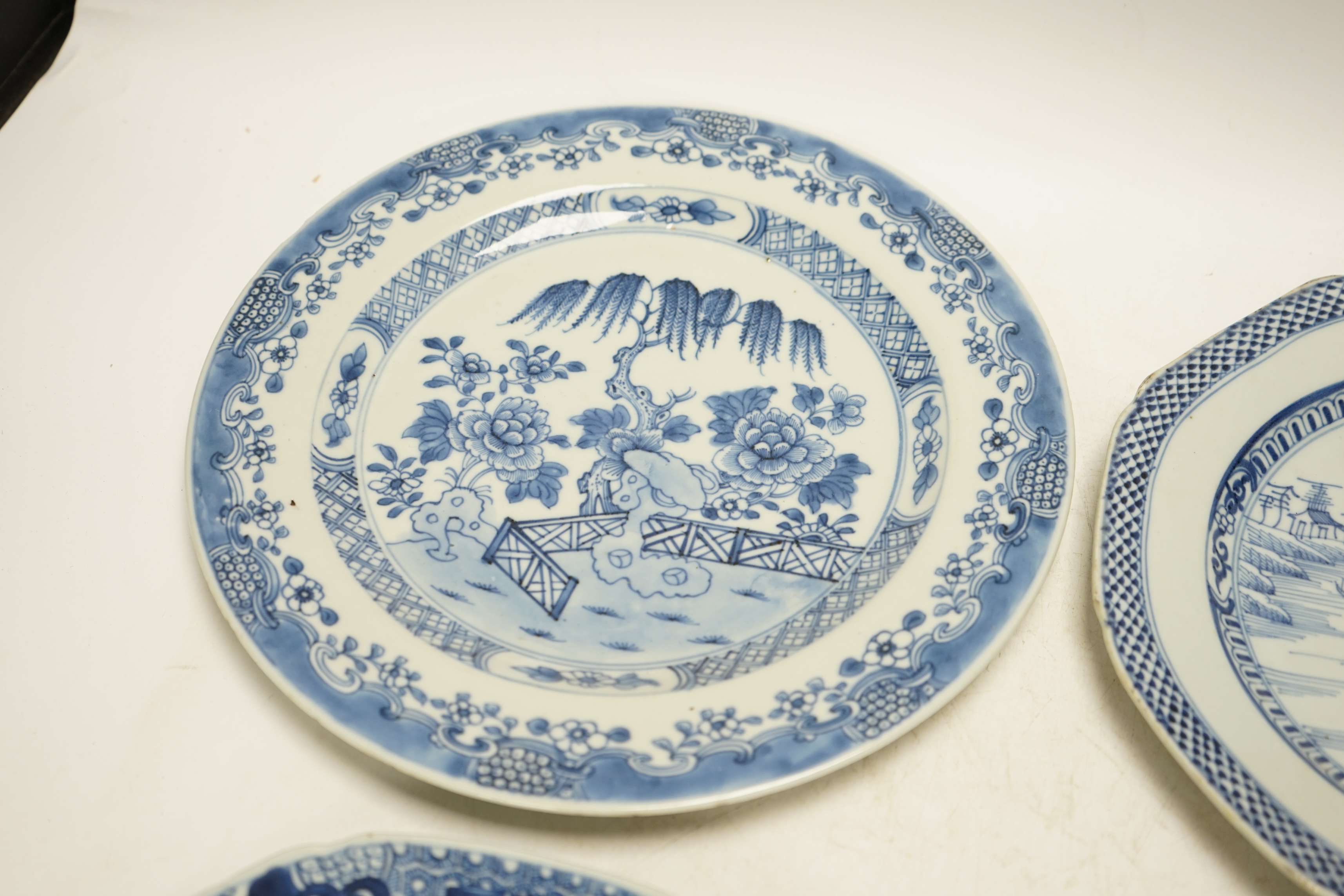 Four various Chinese export blue and white dishes, 18th/19th century, largest 26cm, largest 26cm diameter. Condition - one plate cracked, chips to another
